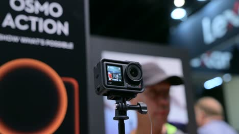 ifa berlin 2023: close-up of osmo action camera on display with an arc movement, showcasing its high-definition screen and compact design for adventurous videography and action shots