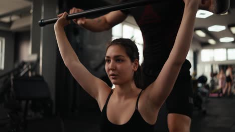 woman training with a personal trainer at the gym