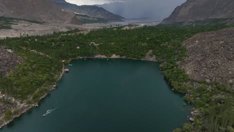 Bird's-eye-view-drone-shot-of-upper-kachura-lake-in-Skardu-with-high-mountains-in-the-background