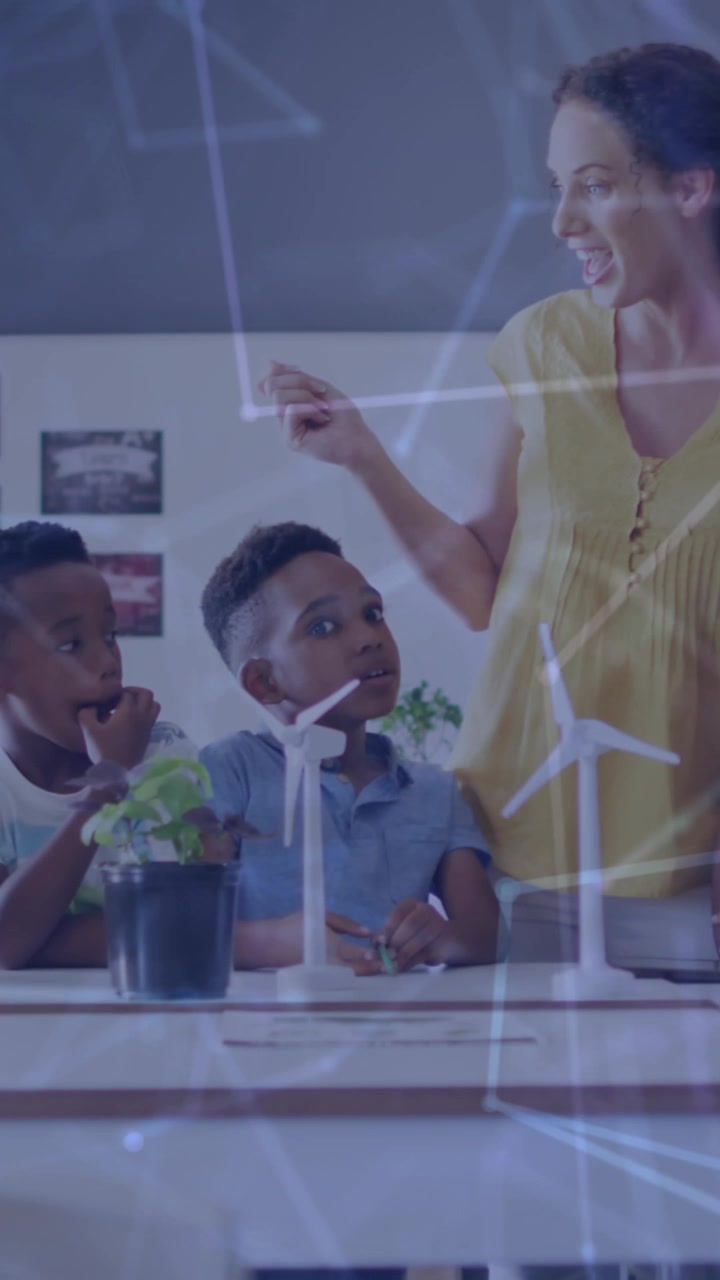Animation of network of connections over happy diverse female teacher and pupils with wind turbines