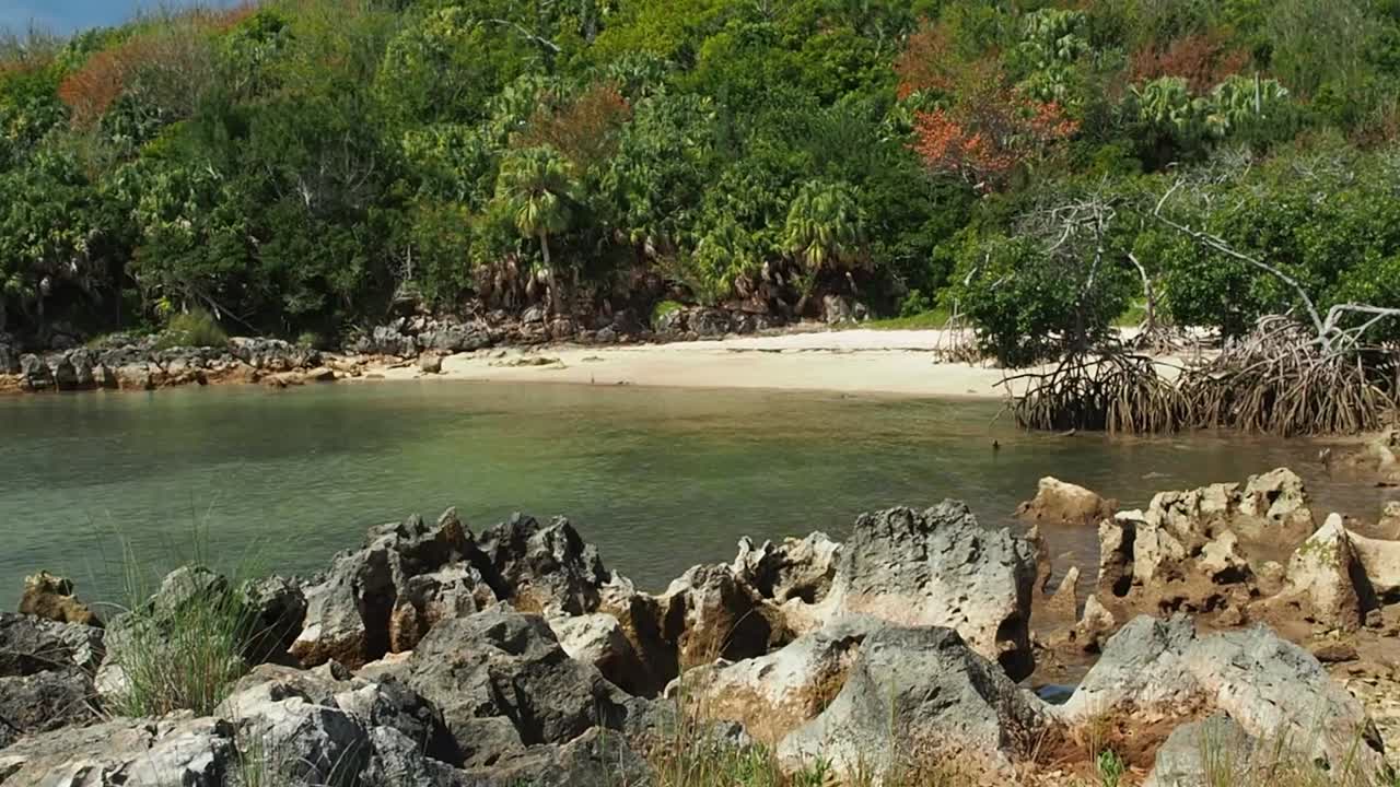 Secluded Tropical Beach with Rocky Coastline