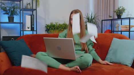 stressed teen girl looking at unpaid bank debt loan, doing paperwork, planning budget, throws bills