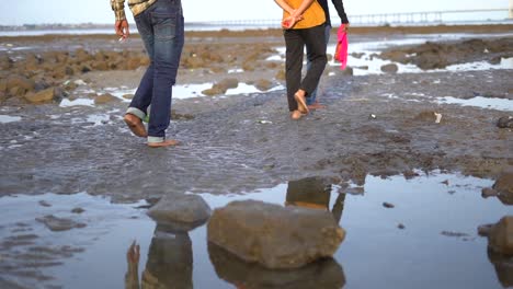 boys waking in mahim beach in closeup view in mumbai