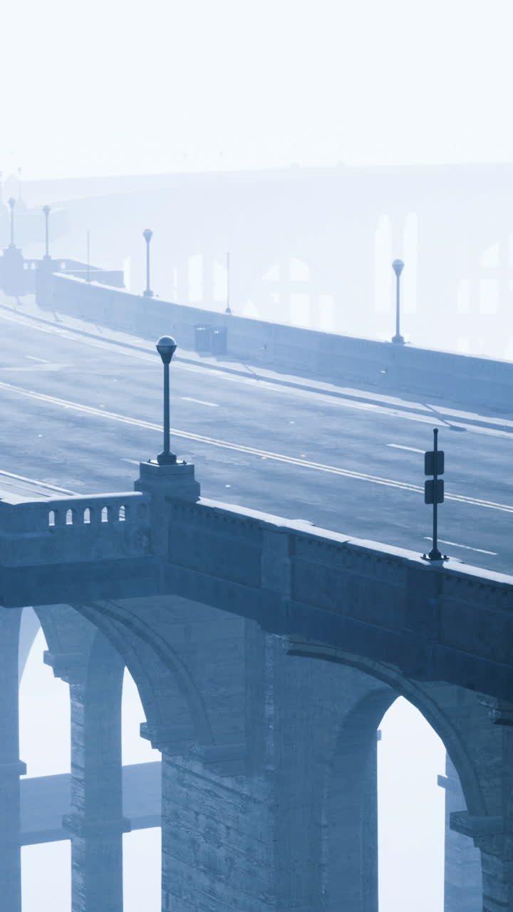 Winding bridge stretches gracefully through thick mist