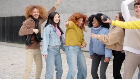 Multi-ethnic young friends dancing in the street