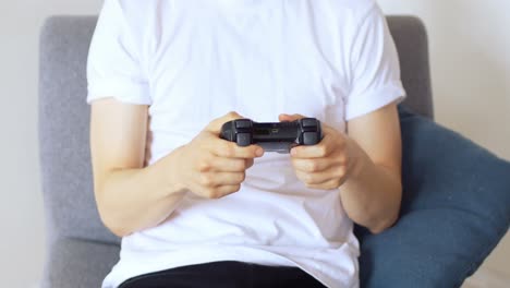 man playing with joystick in living room 4k