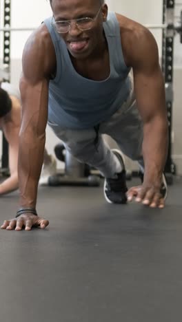 people doing push-ups in a gym