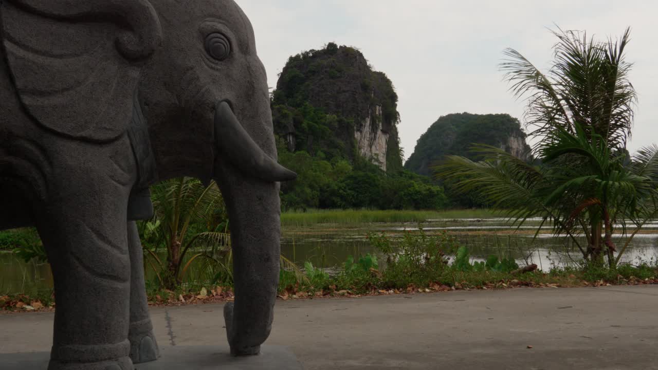 Elephant Statue in Front of Karst Mountains and Lake