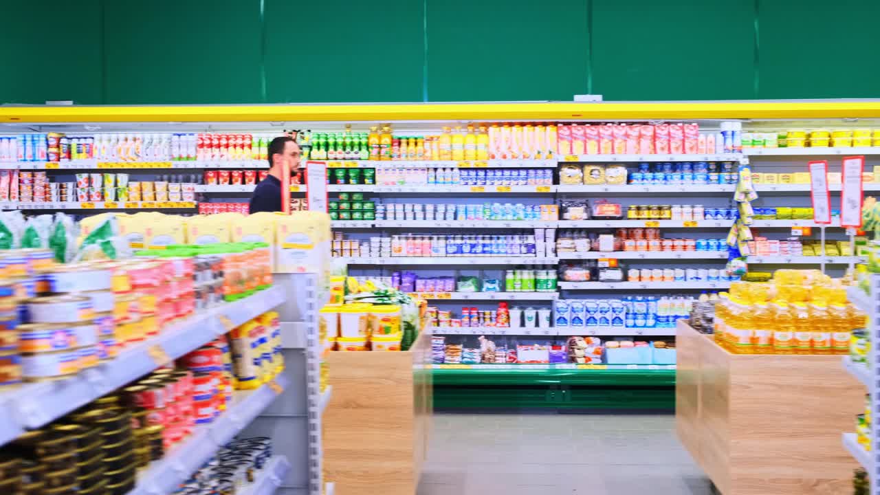 Exploring Aisles of Grocery Store: Shoppers Navigating Shelves Filled with Variety of Food Products and Essentials in a Bright Supermarket Environment