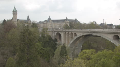 stunning view of the old part of luxembourg city with traffic driving over adolphe bridge