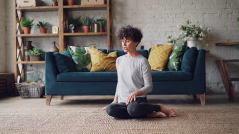 woman doing yoga stretches at home