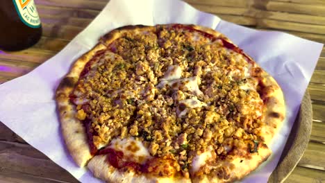 person enjoying pizza with a beerlao drink