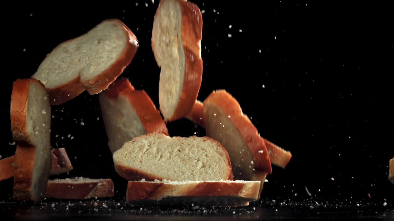 Fresh Bread Slices Falling in Slow Motion on Black Background