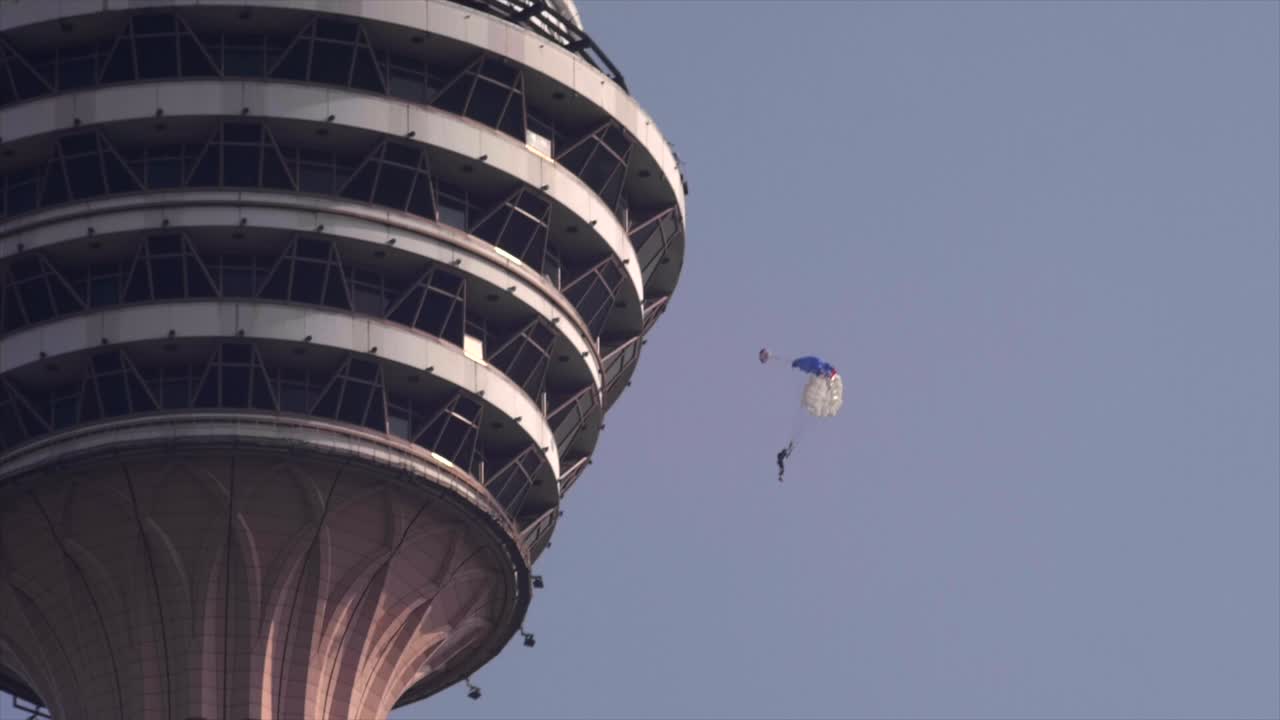 Base jumpers jumping from Menara tower in Kuala Lumpur.