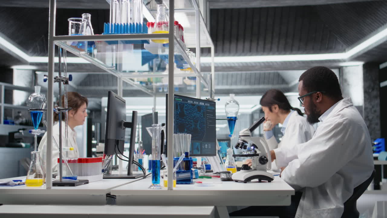 Vertical video Lab microbiologist using microscope for cellular analysis, writing information