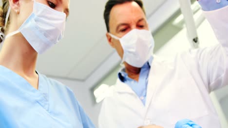 Dentist-and-nurse-examining-a-young-patient-with-tools