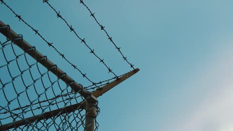 Close-Scenery-of-Wired-Fence-with-Barbed-Wire-and-Mesh-Steel-Wa-During-Rainy-Day---Close-Up-Shot