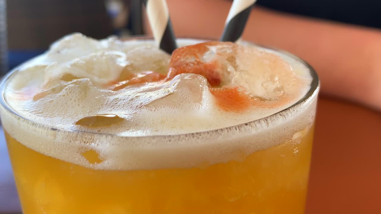 Picking up a tasty summer fruity cocktail in a restaurant, cold refreshing drink, 4K shot