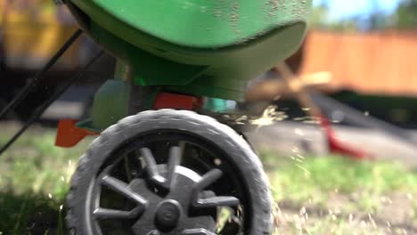 spreading grass seed on a green lawn - slow motion