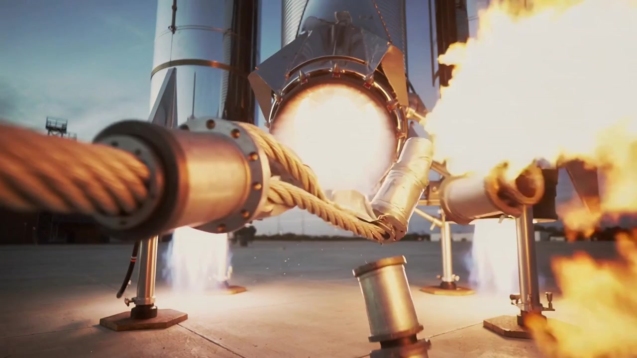 Igniting engine, vertical rocket severing braided umbilical and peeling shroud on pad during test