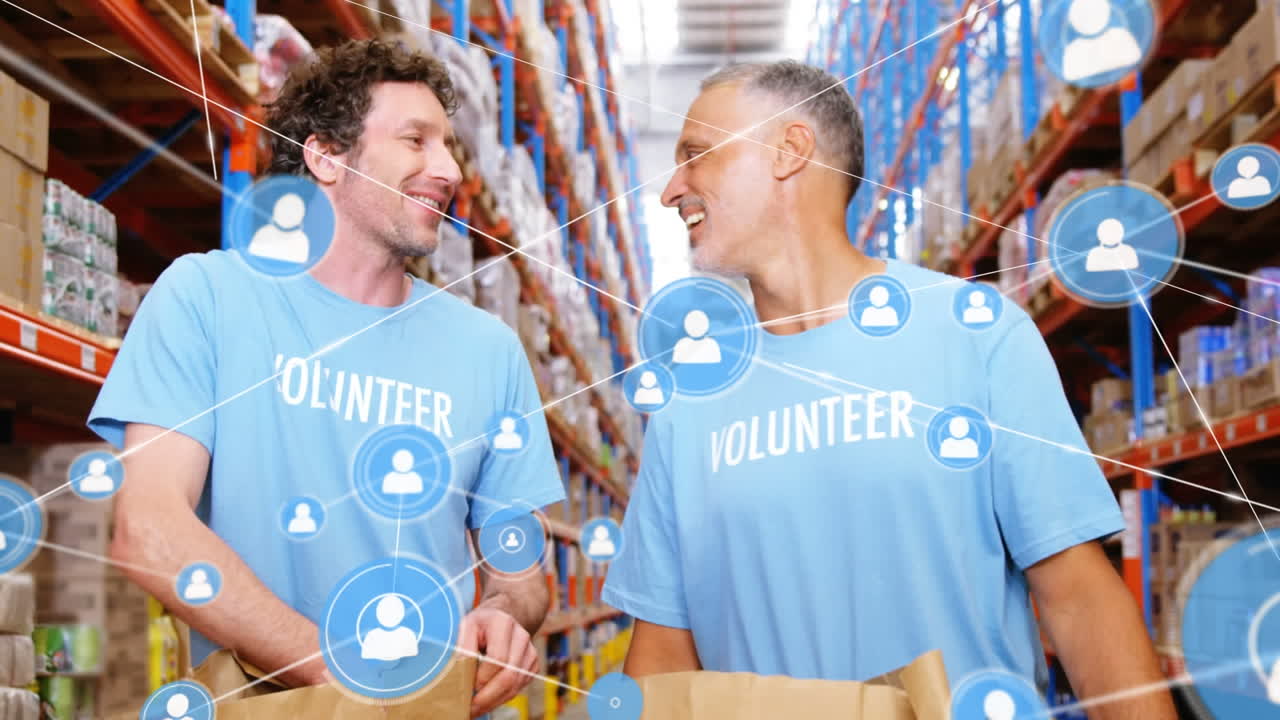 Animation of network of profile over two diverse male volunteers high fiving each other at warehouse