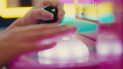 close up of skilled young kid playing video games moving fast the controllers, rack focus between hand