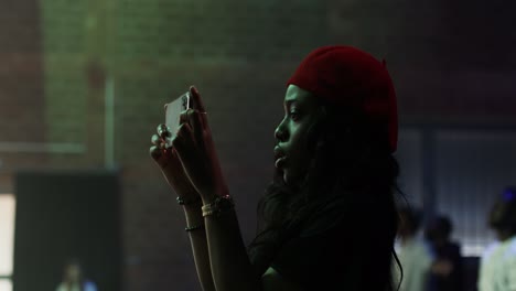 woman taking a photo at a night event