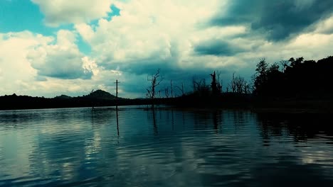 beautiful glass flat surface of a lake reflects the sky as a gentle breeze blows across the water