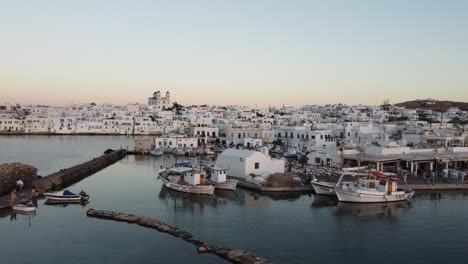 paros, naoussa, greece coastline and traditional white houses during sunset, aerial view