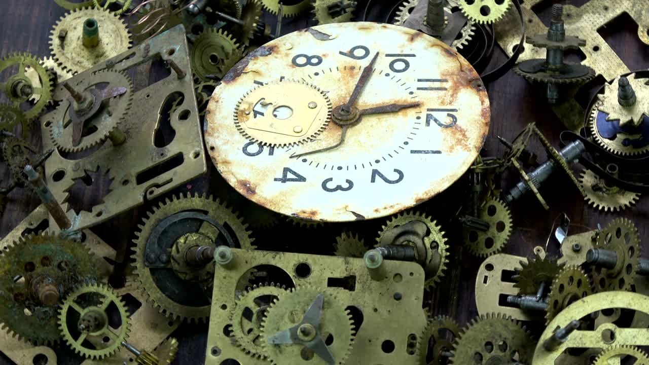 Vintage analog clock brass gears and cogs with rusty dial clock face rotating background