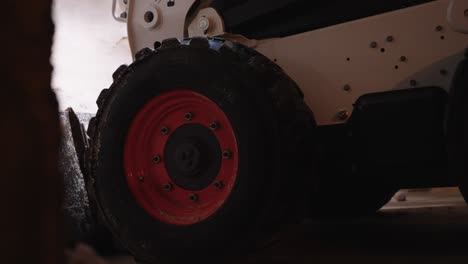 close up of bobcat tractor scooping up salt for salt sprayer to melt snow during winter