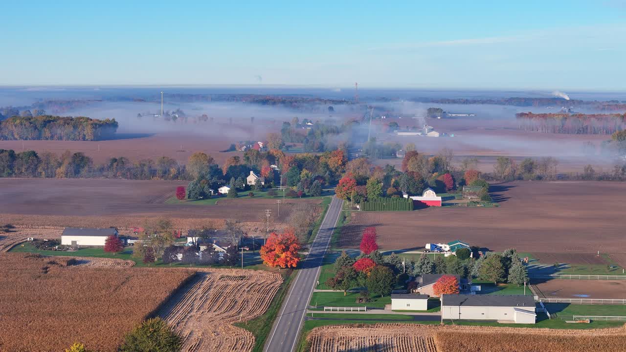 Dense fog blanketing Lake Odessa, Michigan, from an aerial view with community buildings emerging