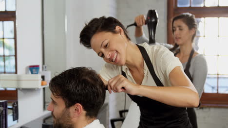 hairdresser trimming her client hair