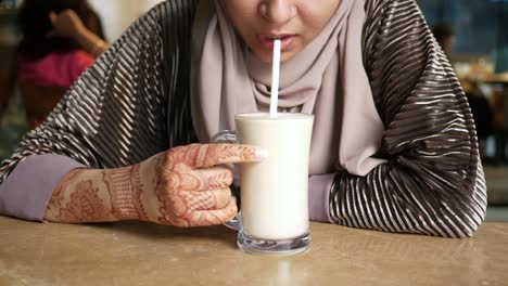 young women drinking banana milk shake at cafe