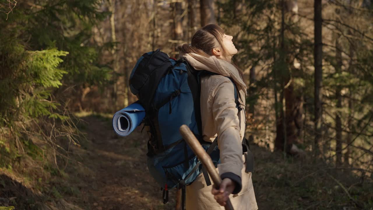 Woman hiking in a forest with a backpack