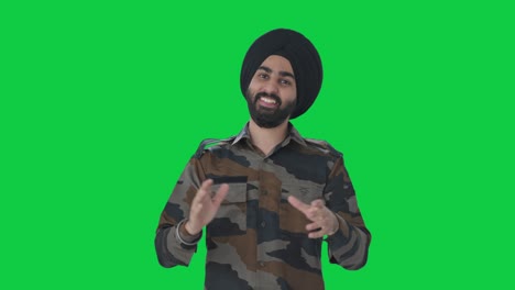 happy sikh indian army man clapping and appreciating green screen