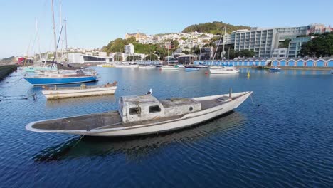 an old abandoned boat docked on the wellington waterfront, new zealand