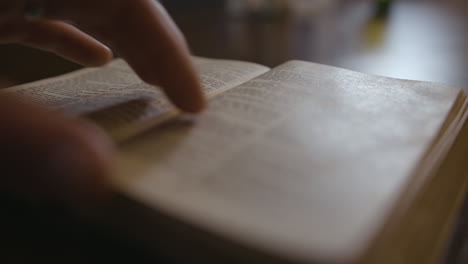 close up of a bible being put down on a table, and pages being flipped through