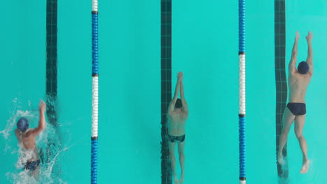 overhead view of multi-ethnic group of male swimmers at a swimming pool