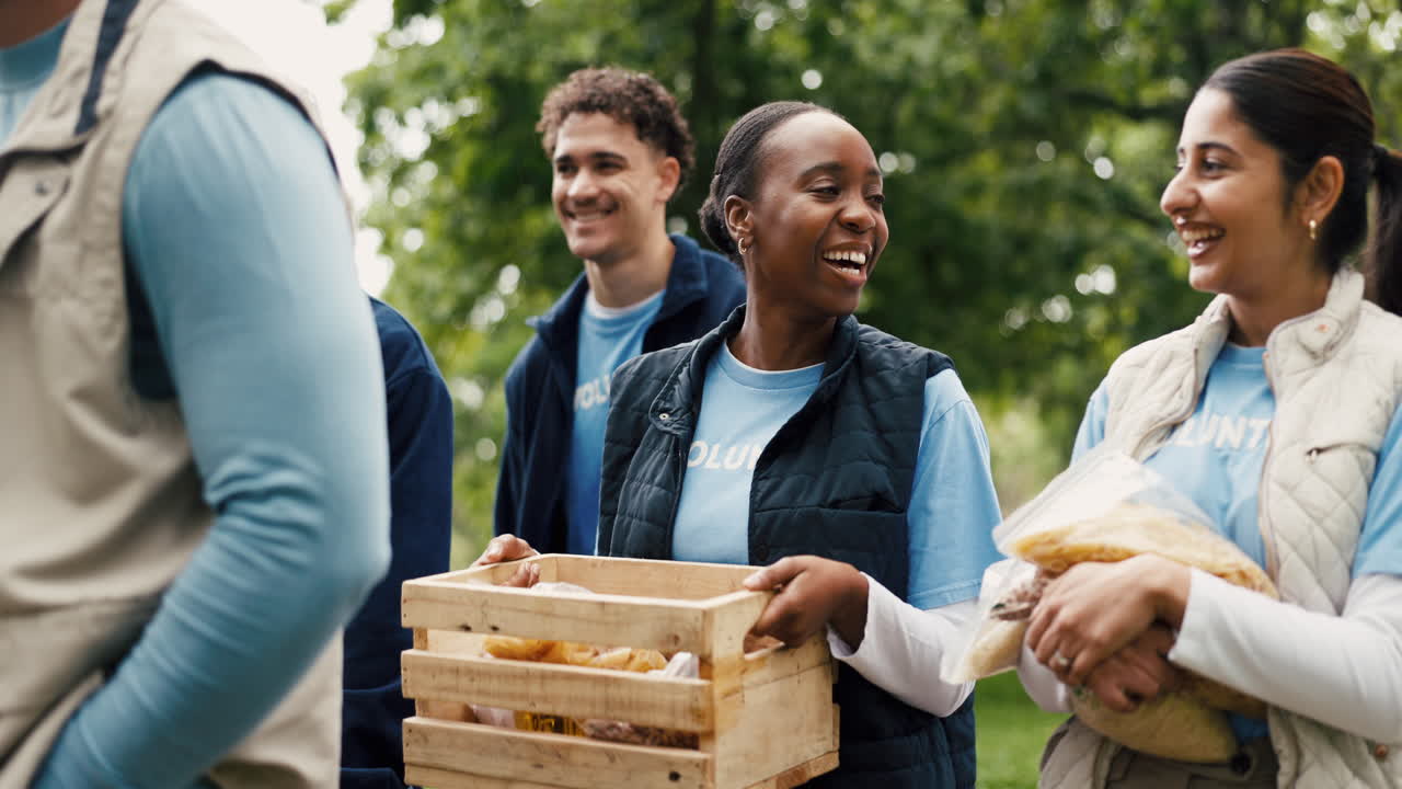 Diverse Group of Happy Volunteers Distributing Food Outdoors