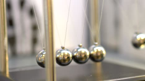 pendulum with swinging metal spheres in 4k slow motion 60fps