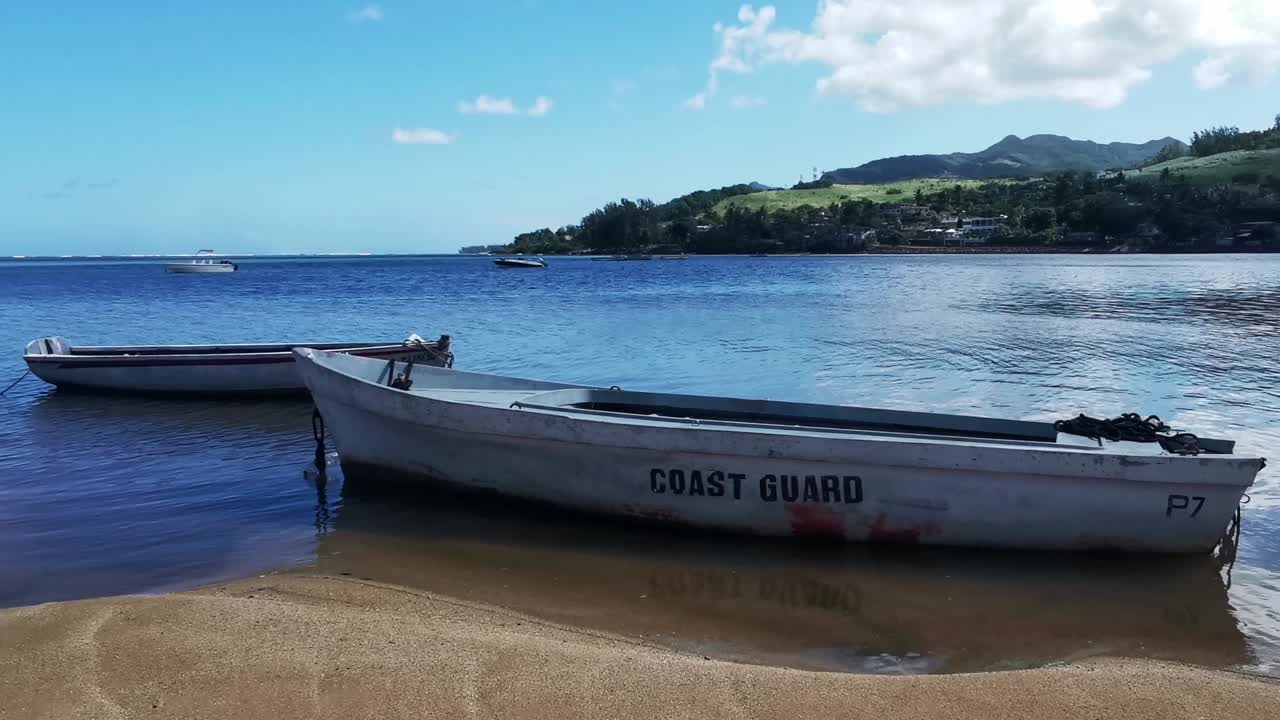 Tropical coast guard boat on shore