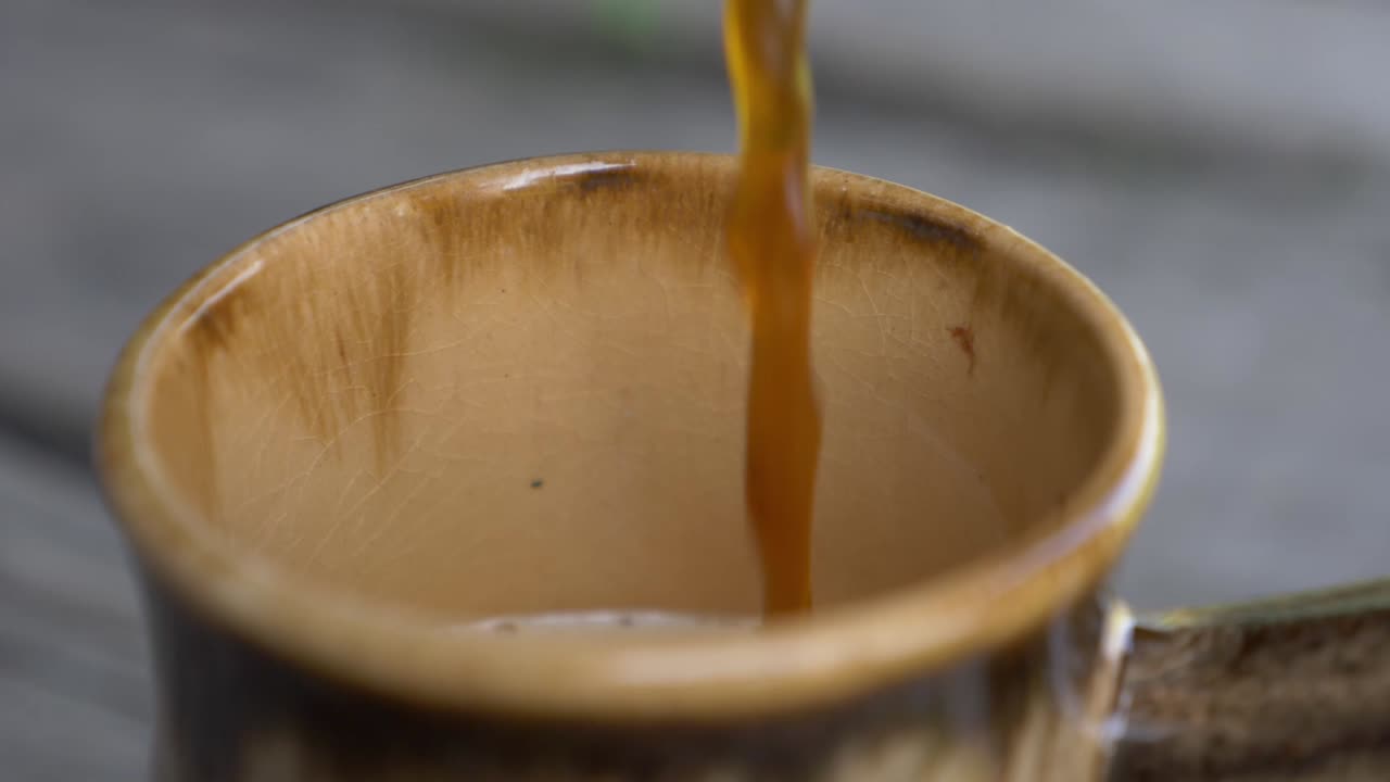 Pouring Beer In a Clay Mug In Slow Motion