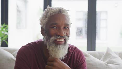 video of happy african american senior man spending time alone