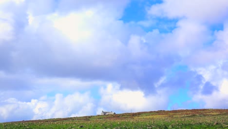 A-small-abandoned-stone-house-is-seen-in-the-distance-across-the-beautiful-Scottish-moors-in-this-time-lapse-shot