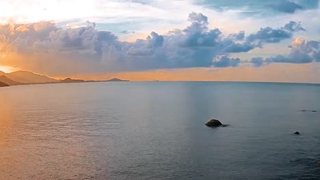 peaceful ocean on a sunny day with clouds over the water