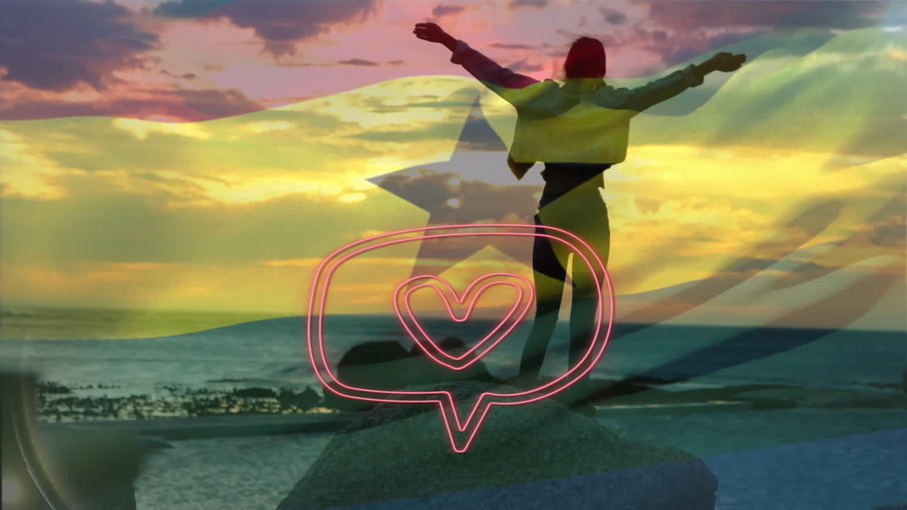 Silhouette of person with arms outstretched over ocean and heart icon animation