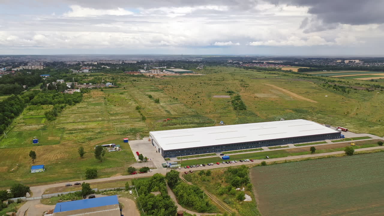 Aerial panoramic view on innovative plant in nature. Modern factory building in the countryside. Aerial view.