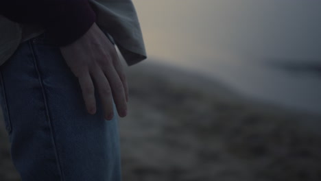 Unrecognizable-man-tapping-fingers-on-legs.-Guy-holding-hand-on-jeans-pocket