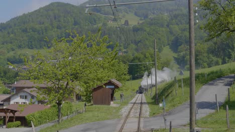 rear view over railway tracks as train is moving away